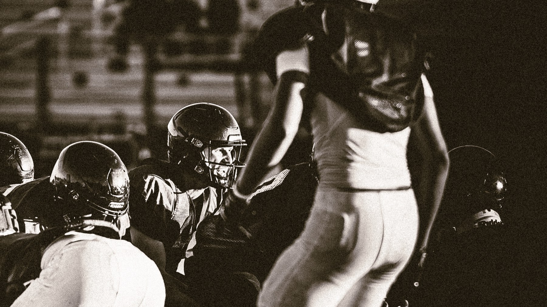 Arroyo Grande teammates on the sideline, black and white