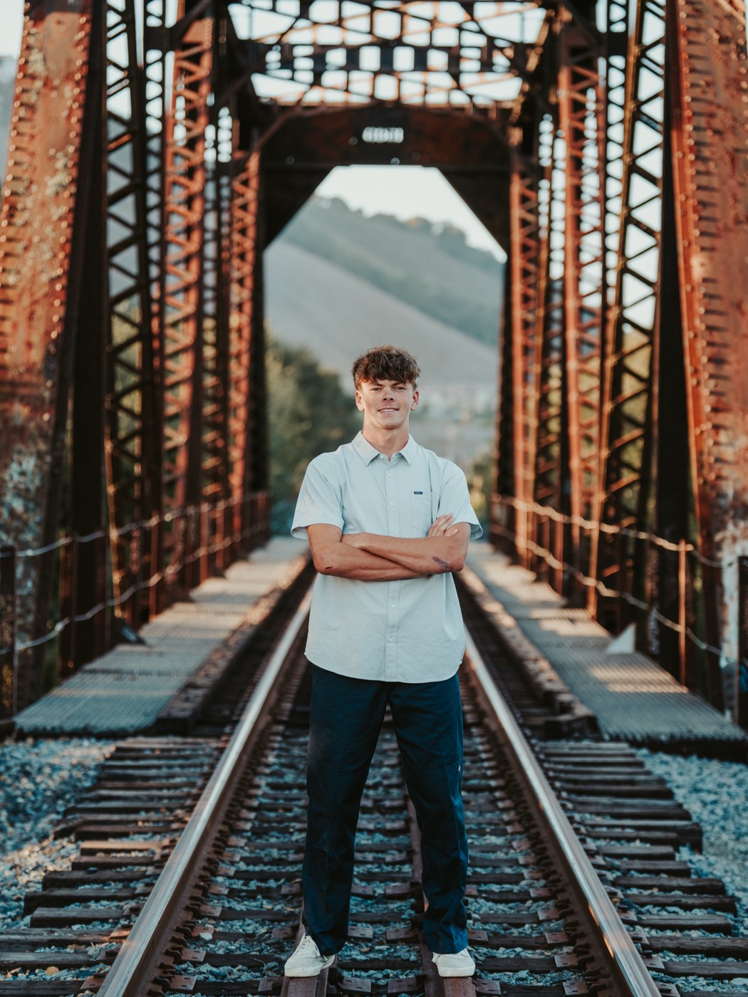 Senior portrait framed inside a historic railroad trestle — San Luis Obispo County senior photographer