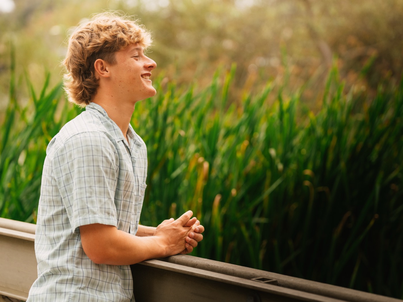Senior portrait laughing beside the wetlands — Central Coast senior photographer