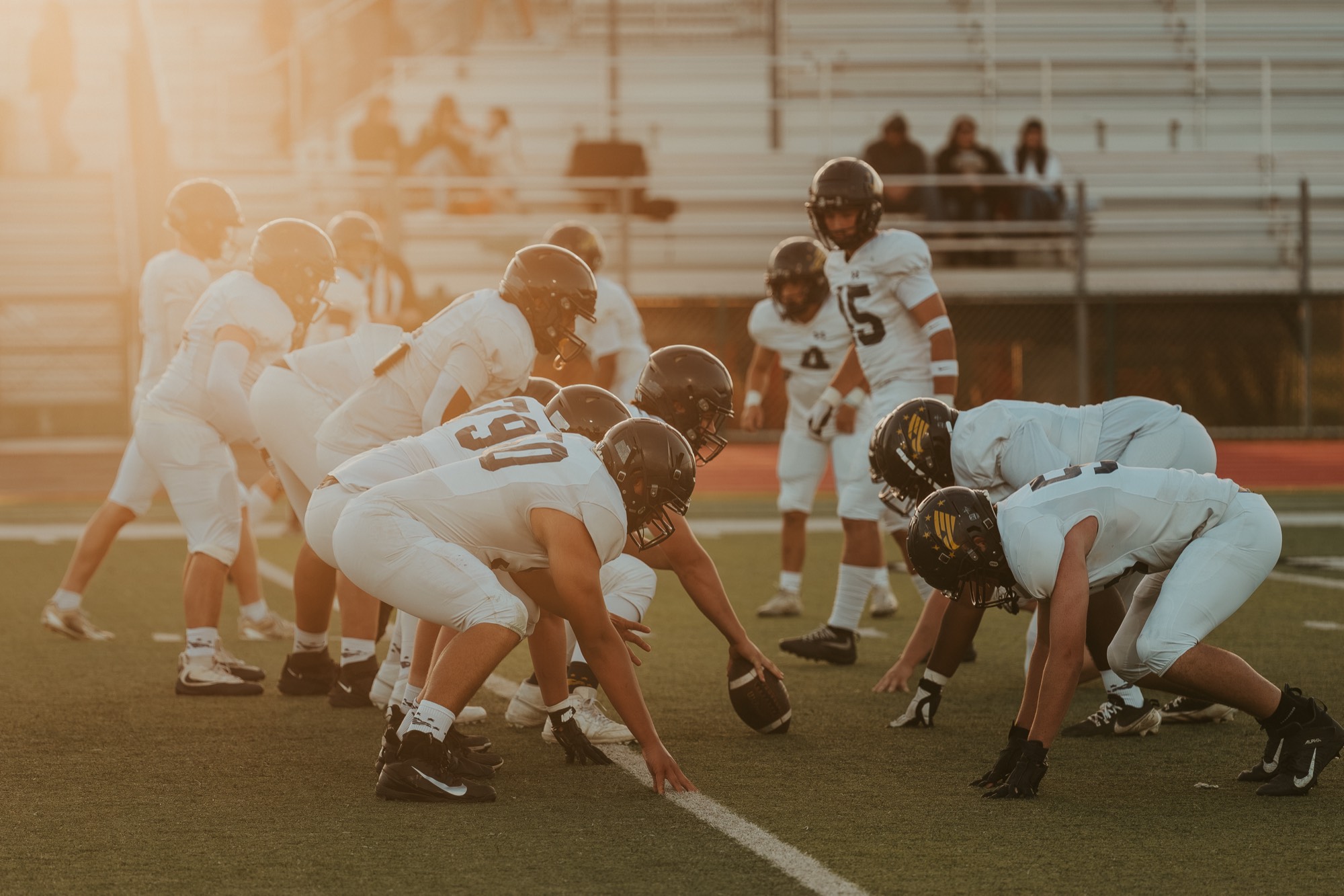 Arroyo Grande offensive line at the line of scrimmage in evening light